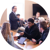 Photo of students talking with each other in a classroom